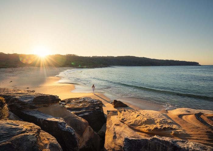 Woman walking at sunset , Congwong Beach, Kamay Botany Bay National Park