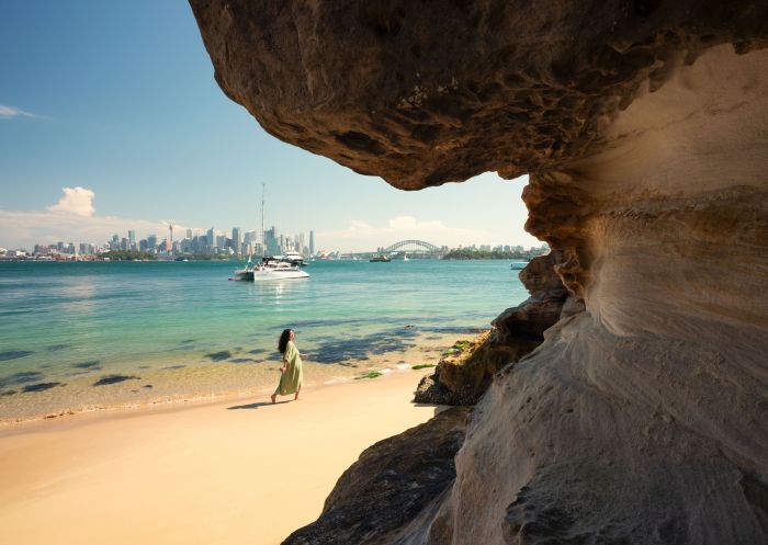 Woman walking near stone and harbour , Athol Beach, Mosman