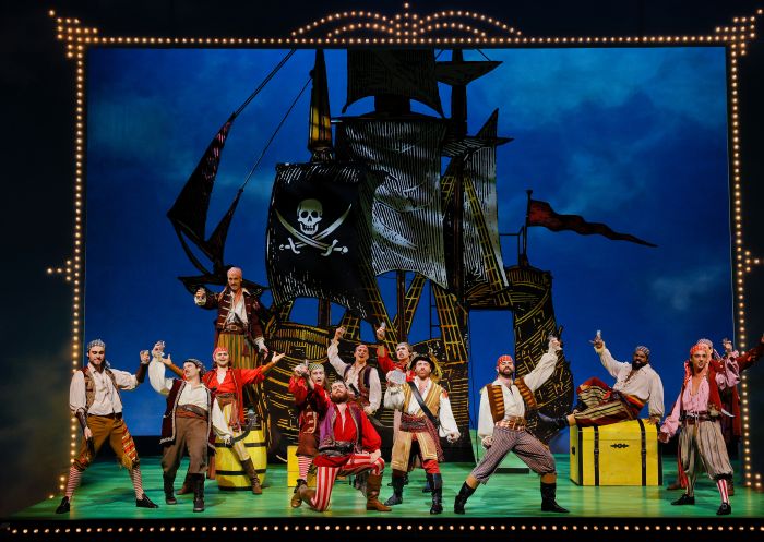 Cast performing on stage with pirate ship, The Pirates of Penzance, Sydney Opera House - Credit: Jeff Busby