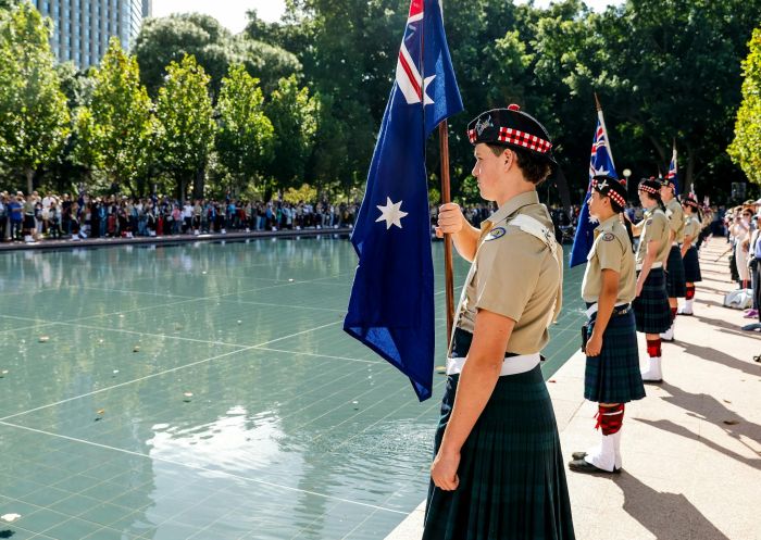 Service woman holding a flag, ANZAC Commemoration Service, Sydney - Credit: Salty Dingo | RSL NSW