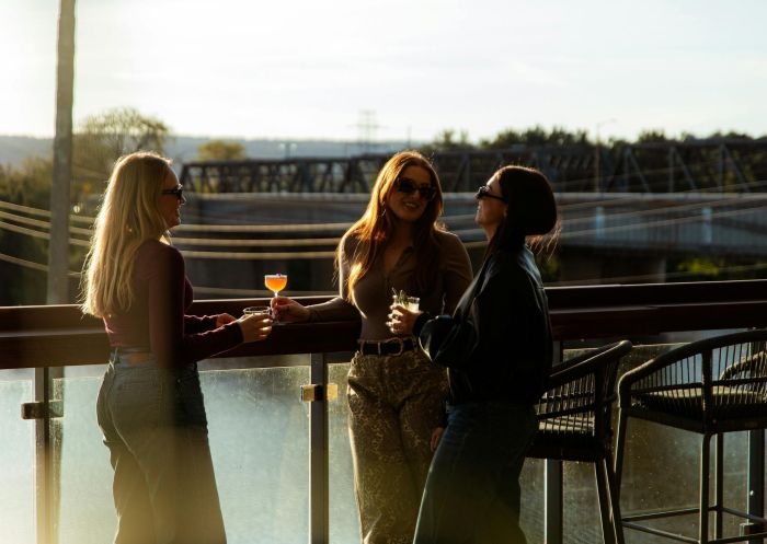 Three women with drinks on balcony, Sinclair's, Penrith - Credit: Sinclair's