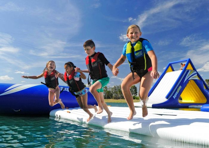 Children jumping off the Aqua Park, Cables Wake Park, Penrith - Credit: Cables Lodge Accommodation