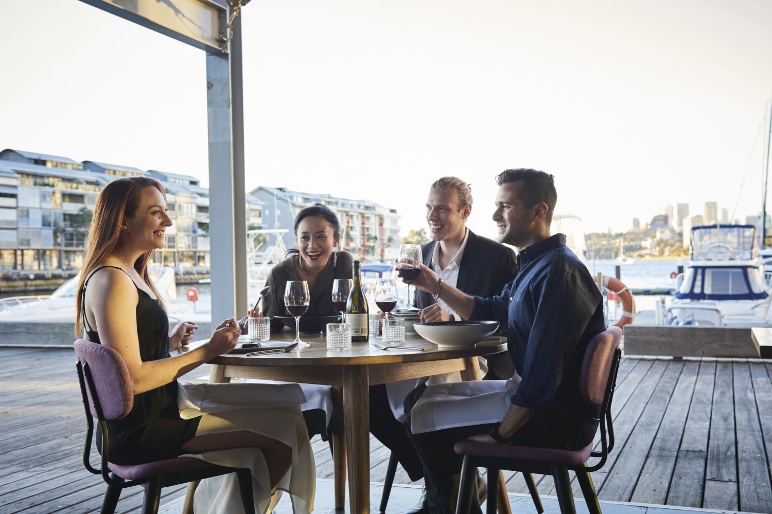 Friends enjoying food and drink at waterside restaurant LuMi Bar & Dining in Pyrmont, Sydney City