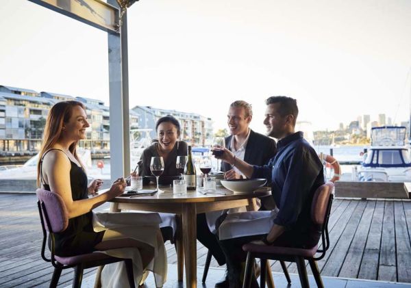 Friends enjoying food and drink at waterside restaurant LuMi Bar & Dining, Pyrmont