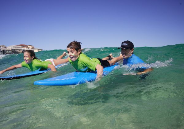 Children learning to surf with 'Let's Go Surfing' at Bondi