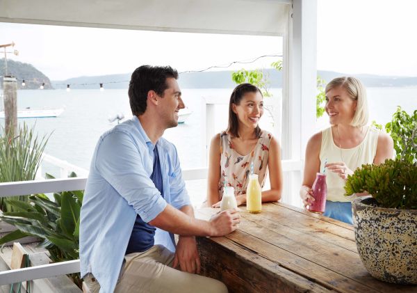 Friends enjoying breakfast smoothies at The Boathouse, Palm Beach