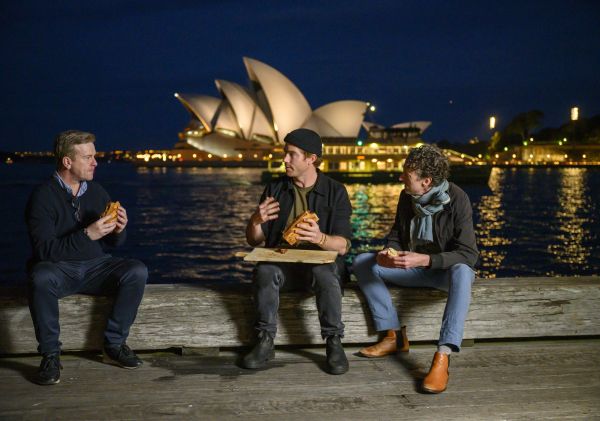 Hayden Quinn, Eoghan Lewis and Mikey Enright tasting the Lemongrass Pork Roll in Sydney Harbour,Sydney City