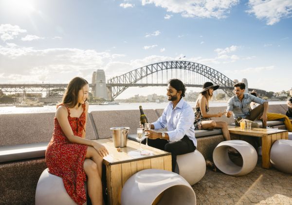 Couple enjoying champagne with harbour views at Opera Bar in Circular Quay, Sydney City