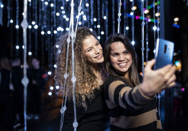 Friends enjoying the Let It Snow light installation in Hickson Road Reserve, The Rocks during Vivid Sydney 2019