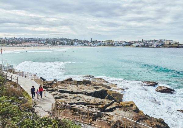 Family walking near stairs on walk, Bondi to Coogee Coastal Walk, Bondi