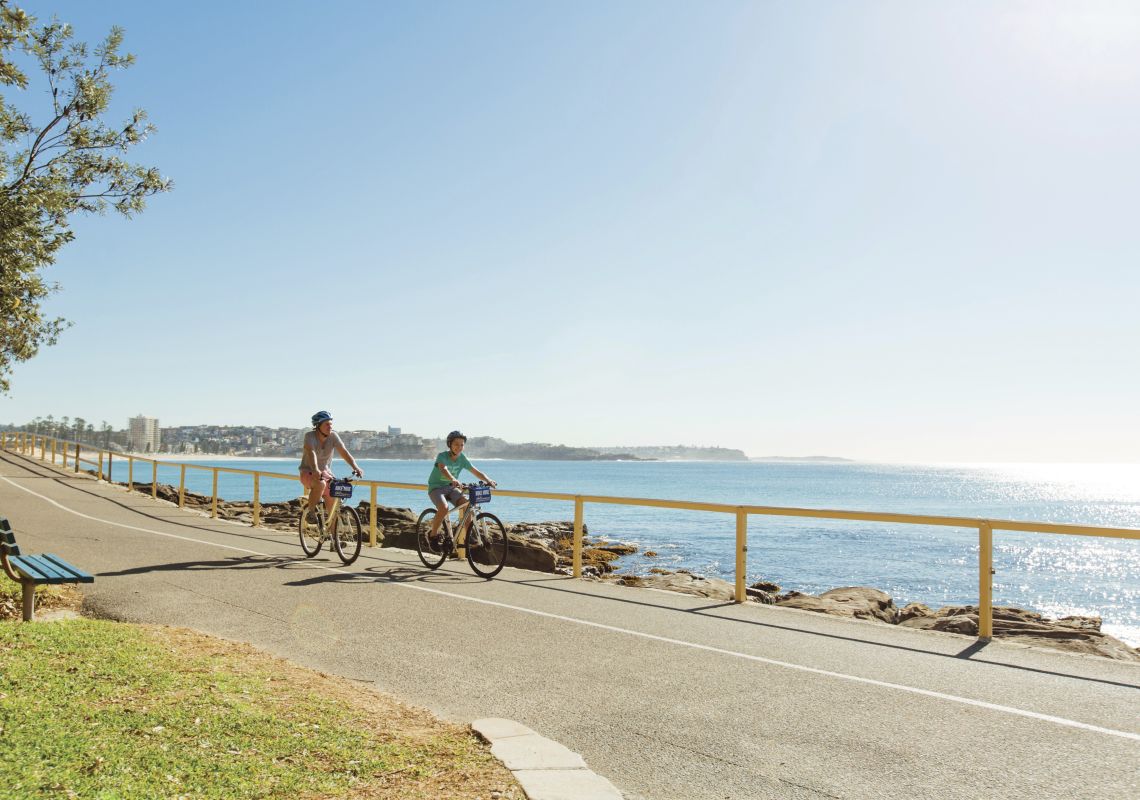 Father and son enjoying a bike ride at Manly Beach in Sydney Cycling, Manly Beach