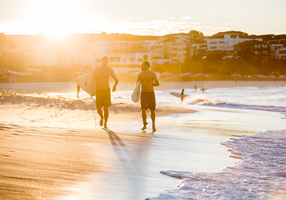 Surfers heading for a morning surf at Bondi Beach Bondi Beach, Sydney
