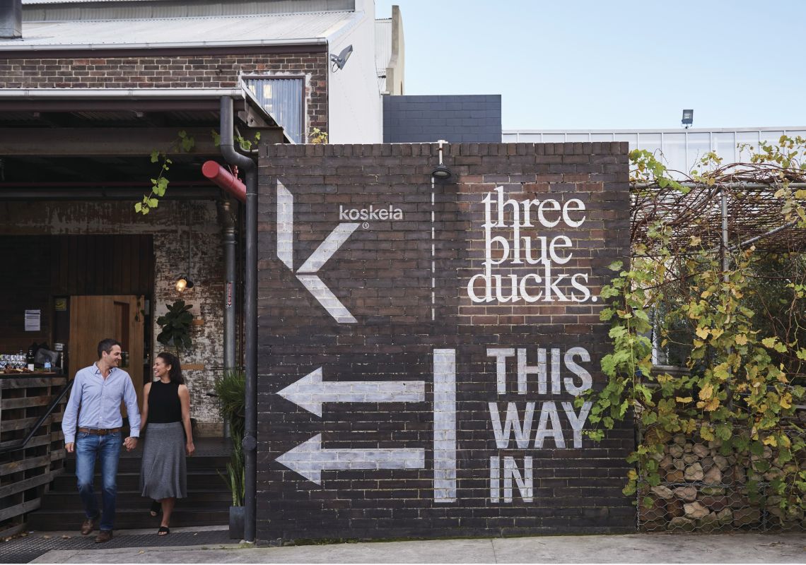 Couple exiting Three Blue Ducks Cafe in Rosebery Three Blue Ducks, Rosebery