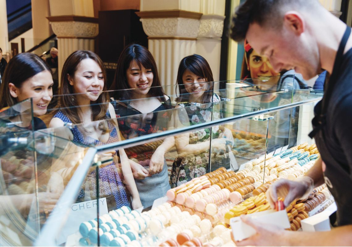Friends ordering macaroons from a store in the Queen Victoria Building Queen Victoria Building, Sydney