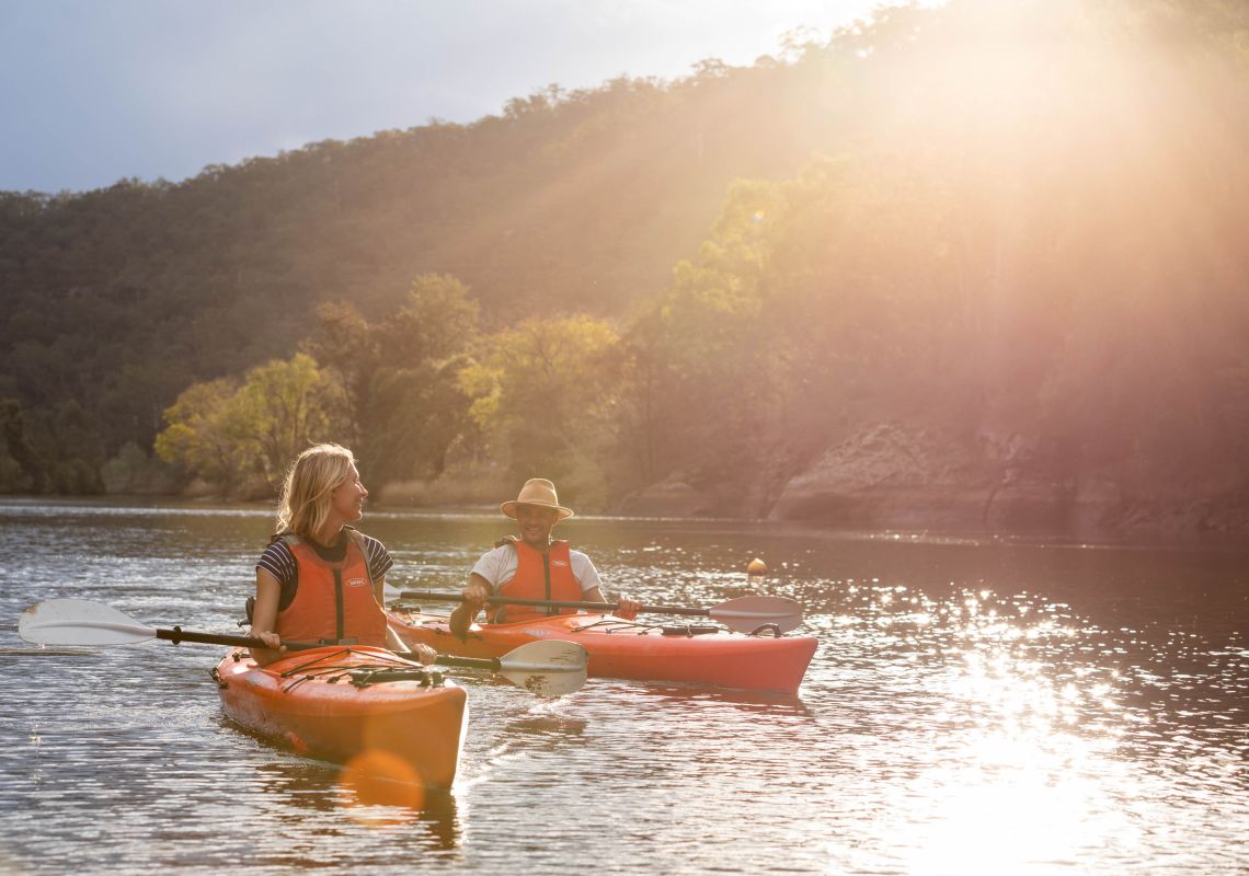 Couple kayaking in afternoon sun, Hawkesbury River 