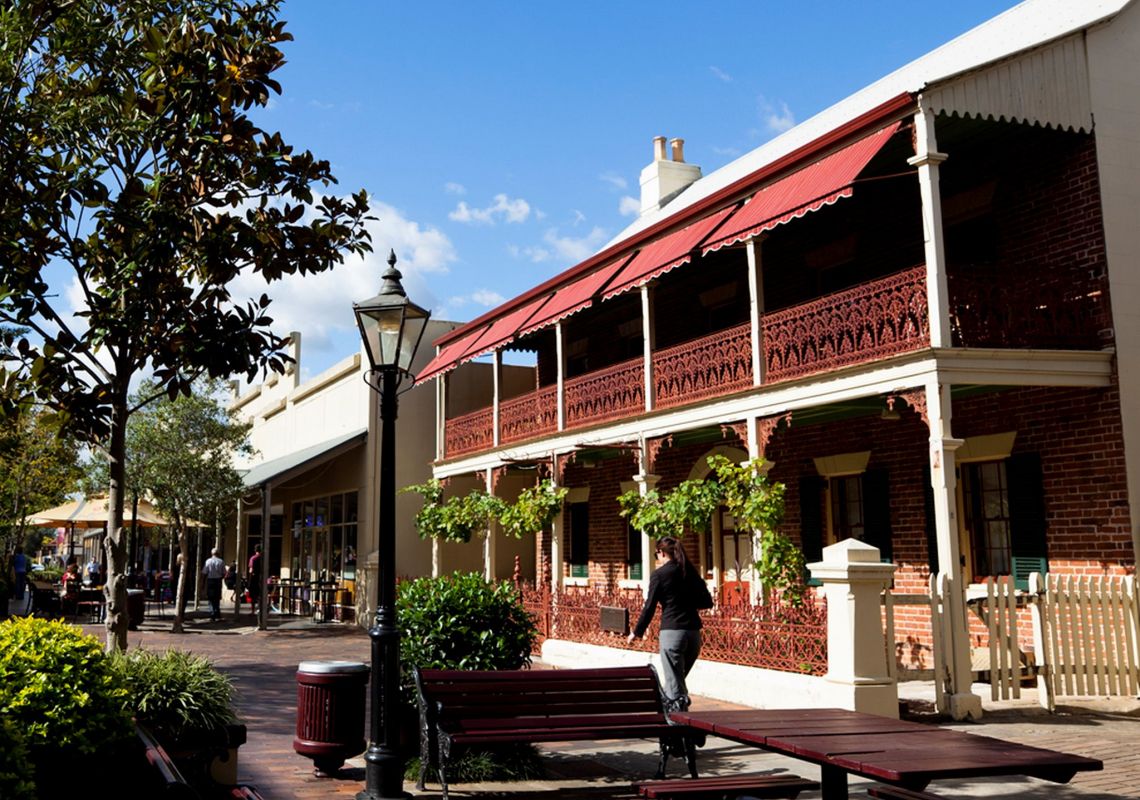 Windsor Mall, Windsor A woman walking by a two-storey heritage building, Windsor