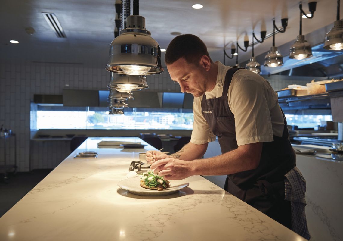 Bennelong Restaurant, Sydney Harbour Chef de Cuisine, Rob Cockerill placing the finishing touches on a dish at Bennelong Restaurant, Sydney