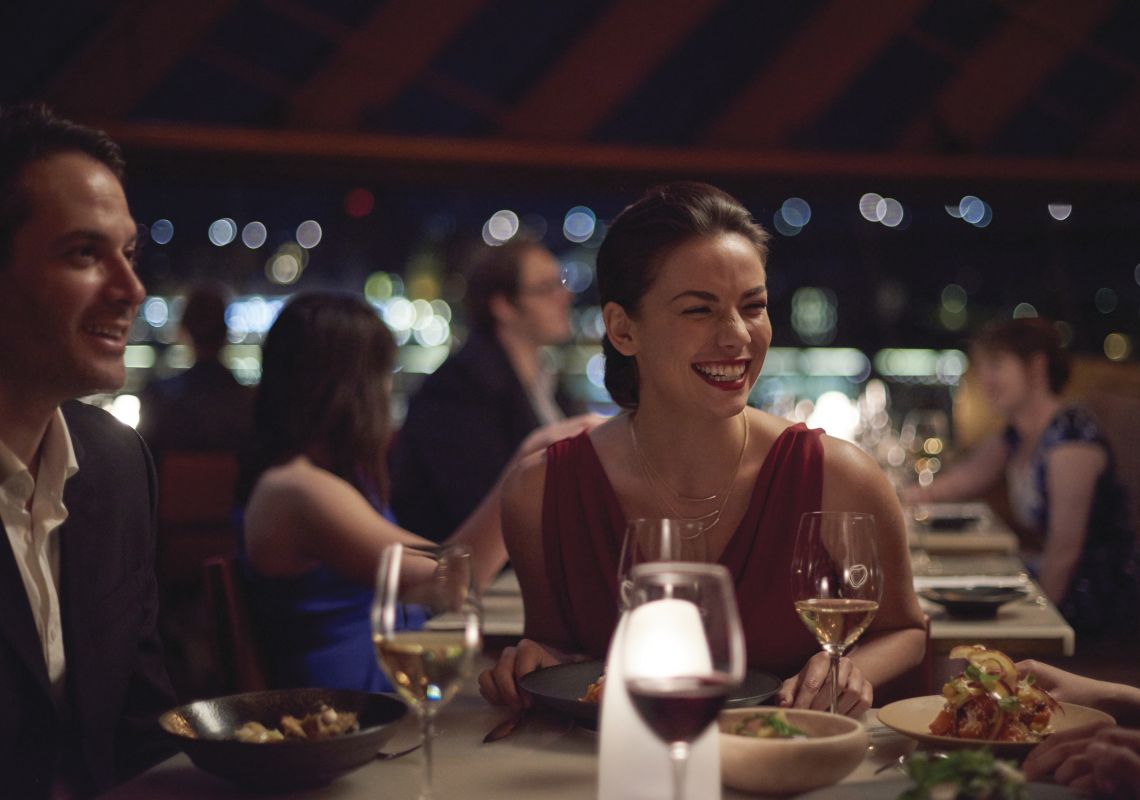 Bennelong Restaurant, Sydney Couple enjoying an evening out with friends at Bennelong Restaurant, Sydney Opera House
