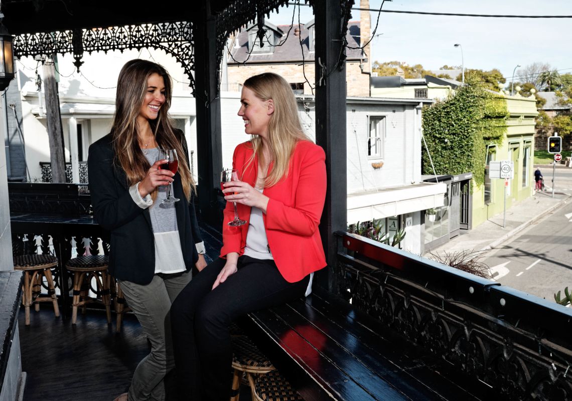 Friends enjoying a glass of wine at The Village Inn in Paddington, Inner Sydney