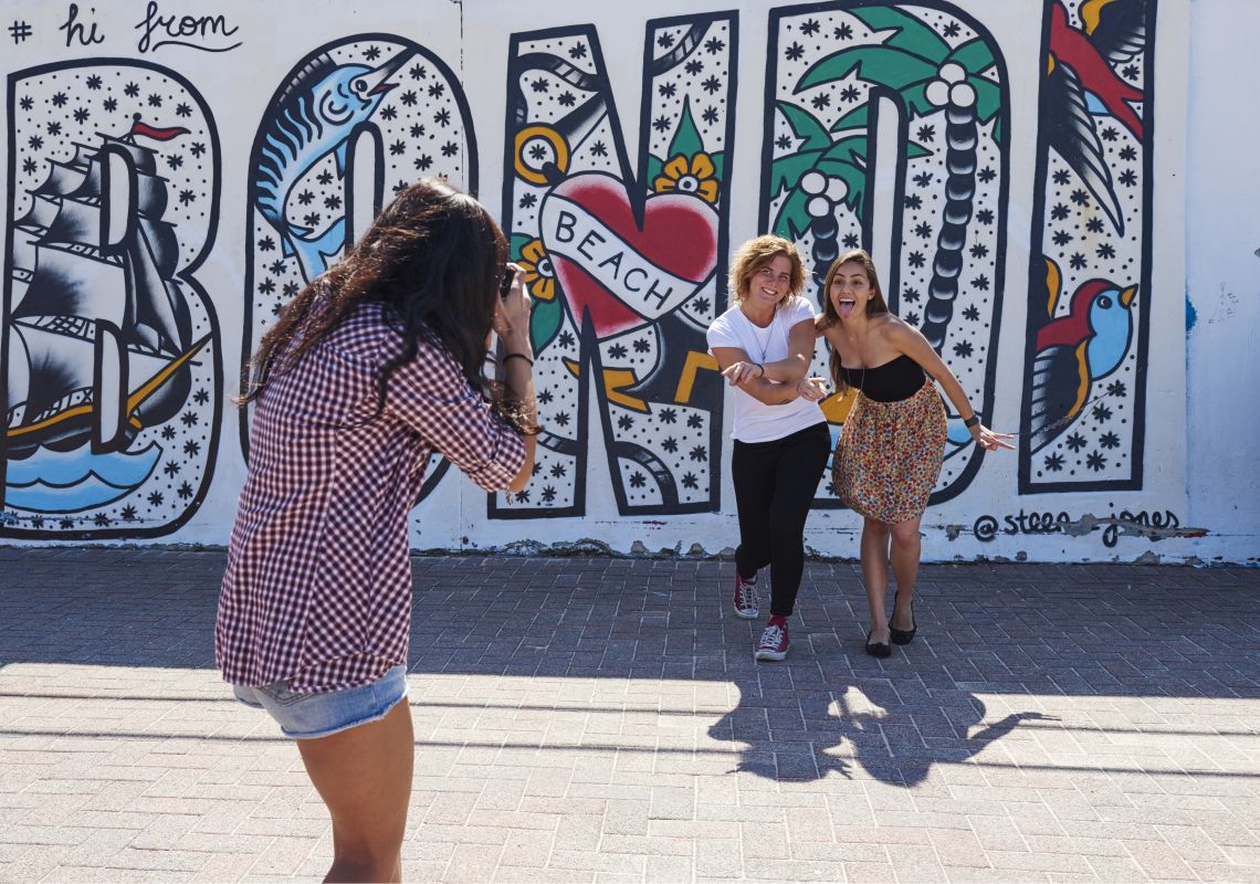 Bondi Beach, Bondi Students taking photos in front of the murals on Bondi Beach in Bondi, Sydney East