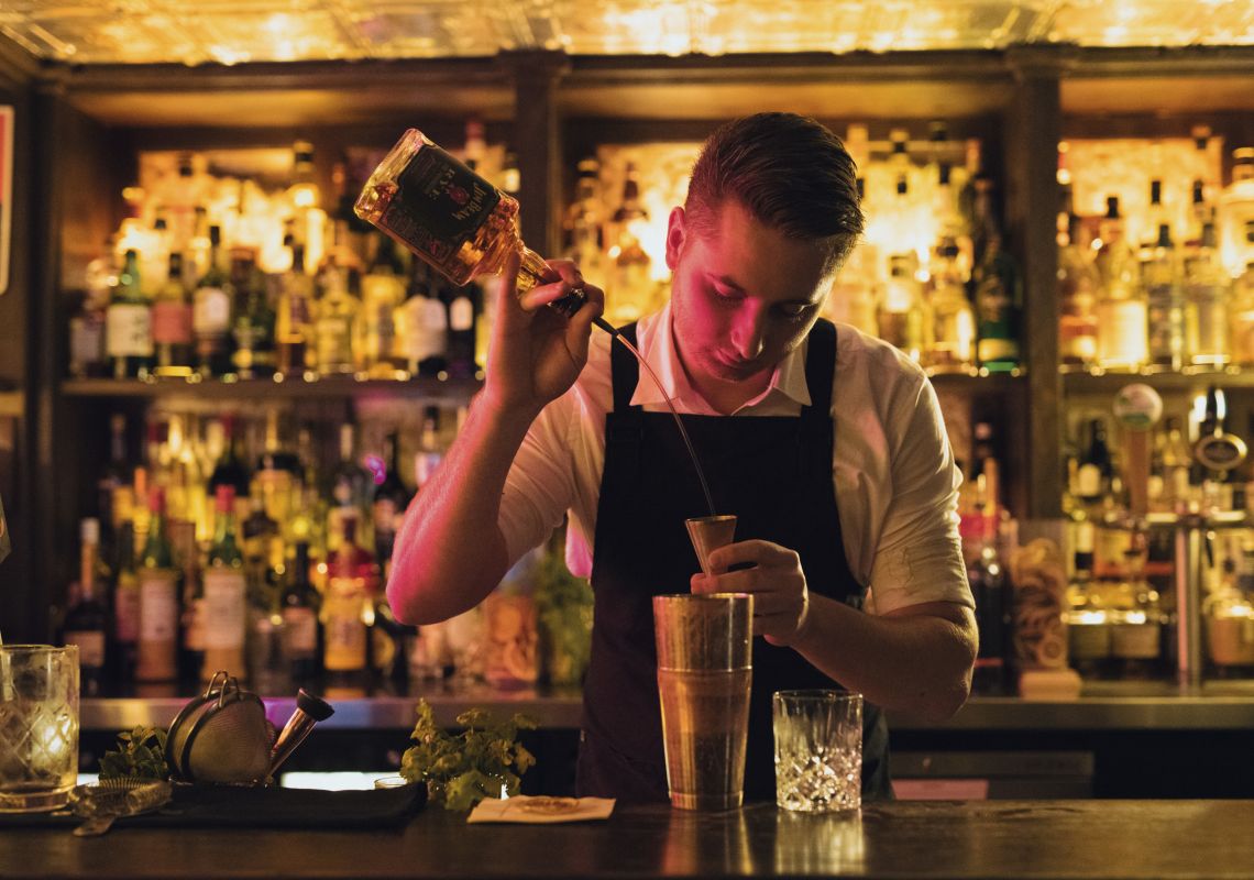 The Doss House, The Rocks Bartender creating a cocktail at The Doss House bar in The Rocks, Sydney City