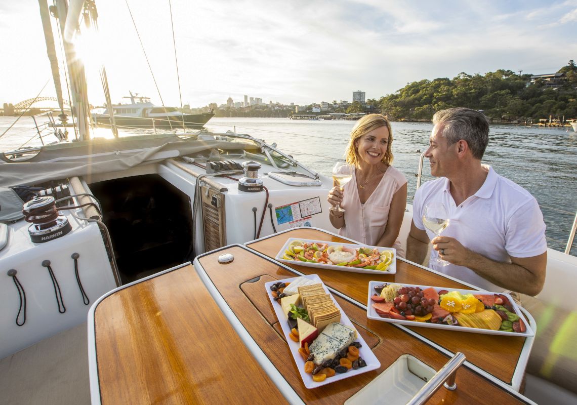 Sailing, Sydney Harbour Couple enjoying food and drink on chartered sailing vessel on Sydney Harbour, Sydney City
