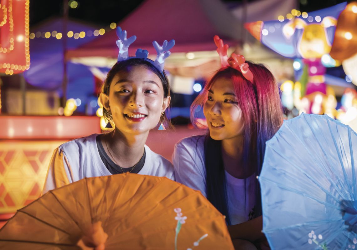 Friends enjoying a night out at the Chinese New Year Lantern Festival 2018 at Tumbalong Park in Darling Harbour, Sydney City