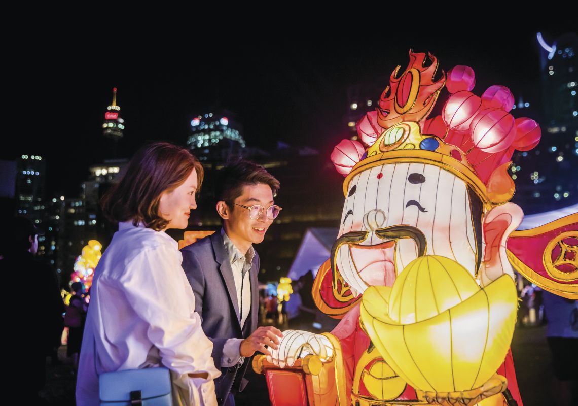 Couple enjoying a night out at the Chinese New Year Lantern Festival at Tumbalong Park in Darling Harbour