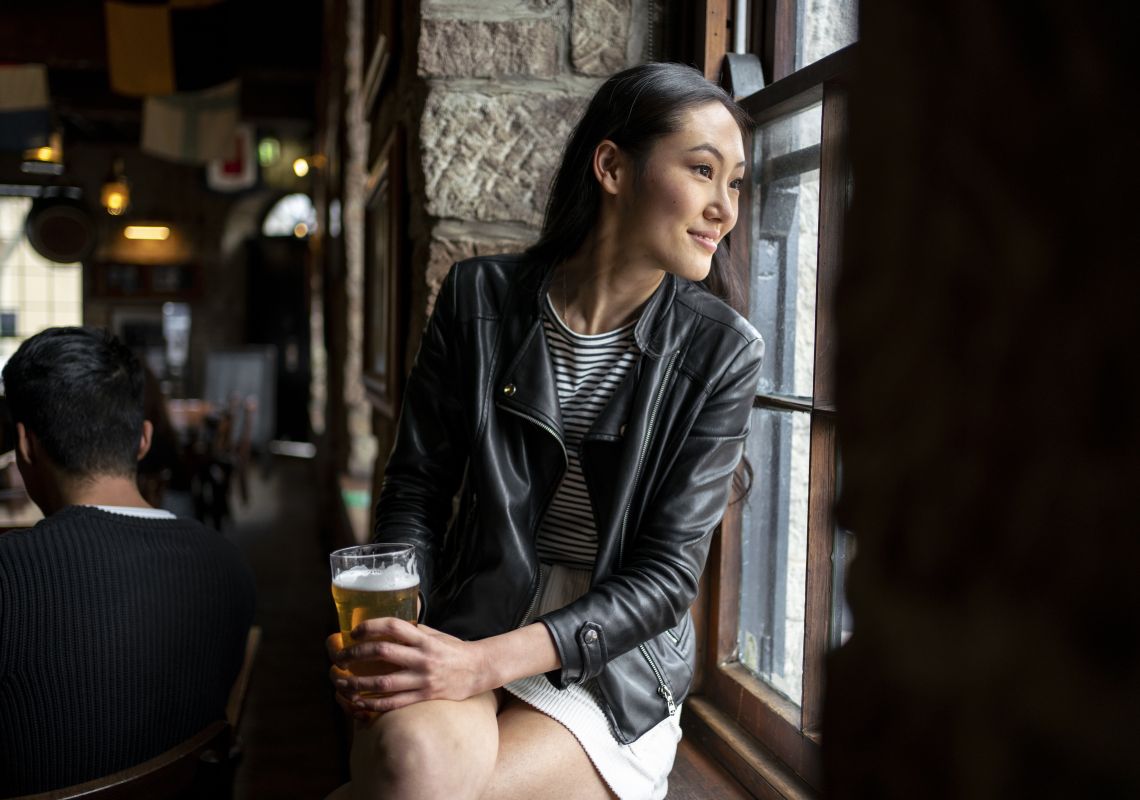Woman enjoying a beer at Lord Nelson Brewery in The Rocks, Sydney