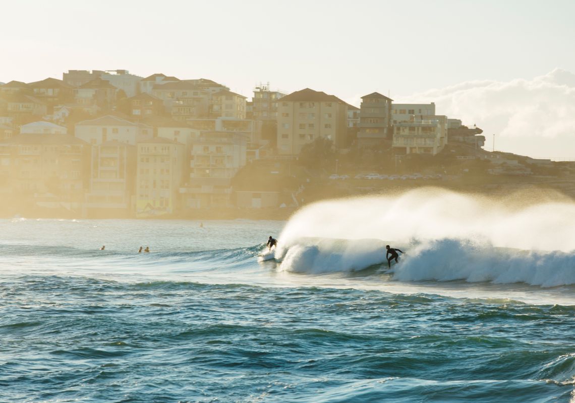 Surfers catching a morning wave at Bondi Beach in Sydney's eastern suburbs