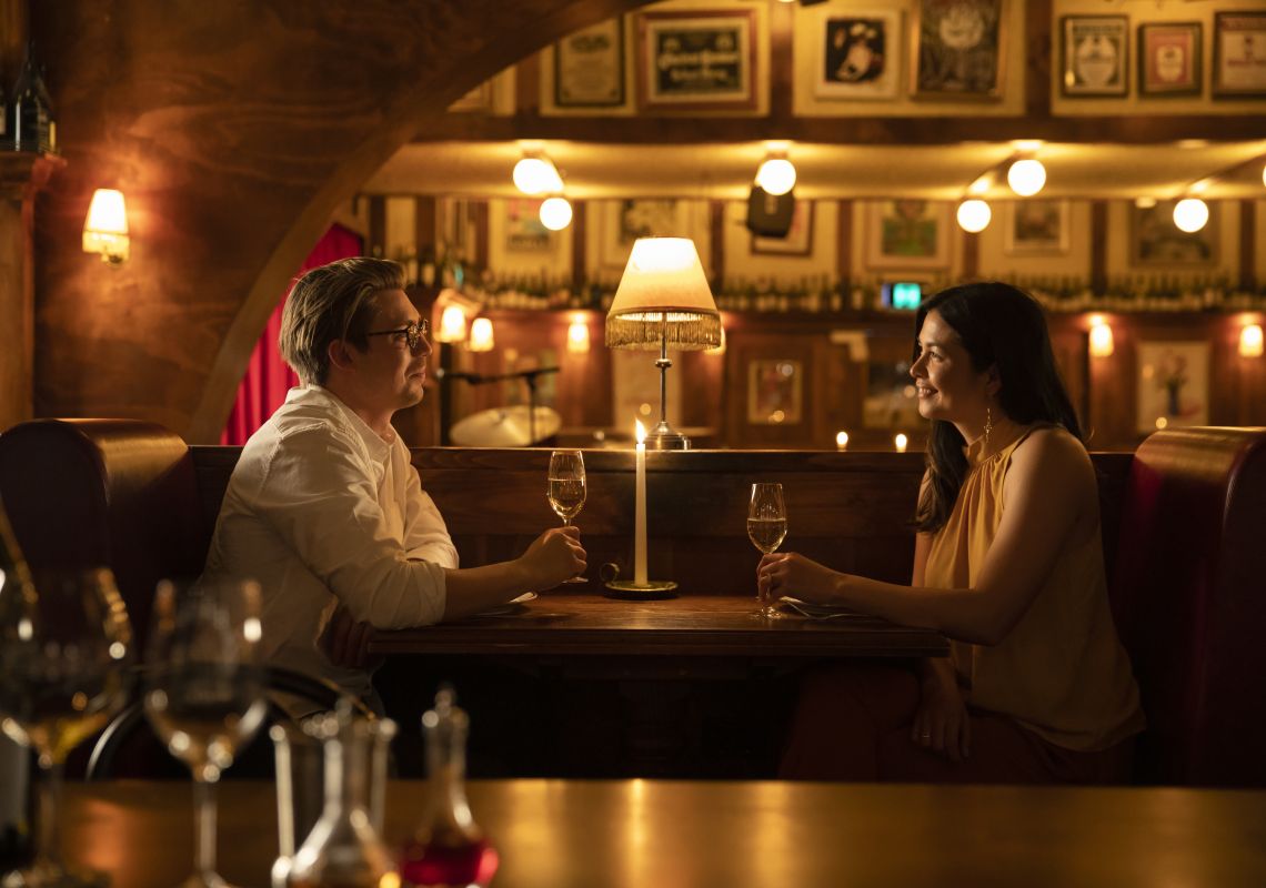 Couple enjoying food and drink at French restaurant Restaurant Hubert, Sydney City
