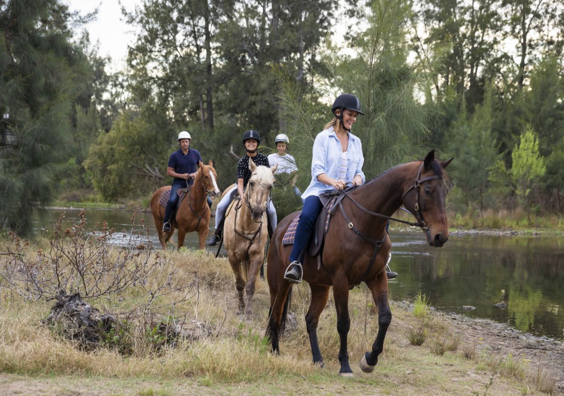 Family enjoying a horseriding experience along the Hawkesbury River with Hawkesbury Valley Equestrian Centre.