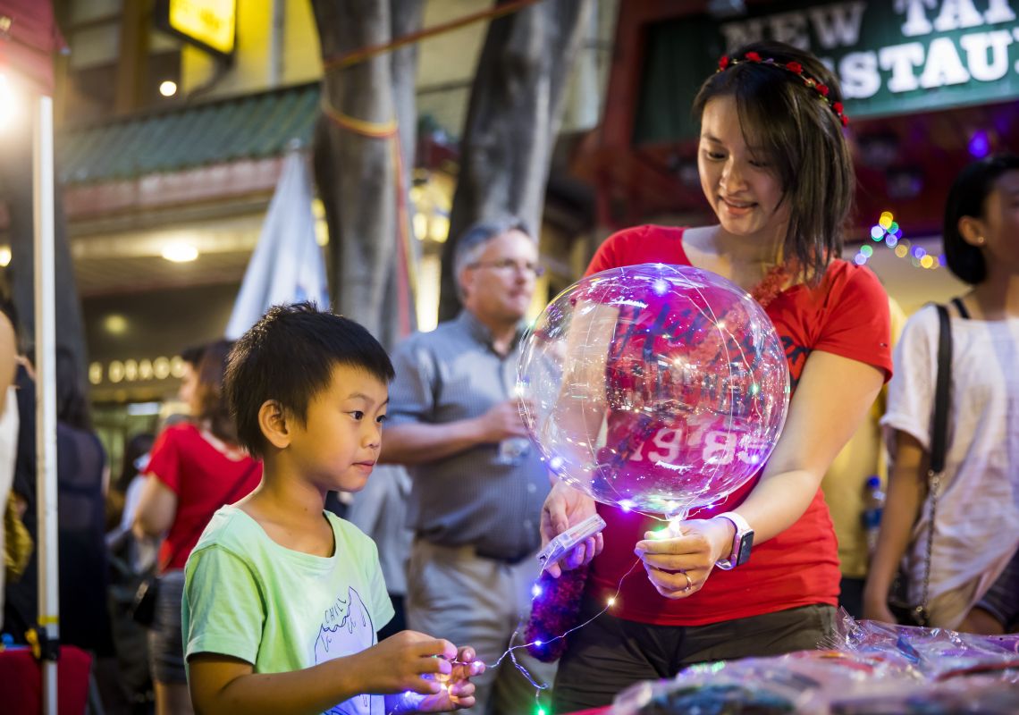 Young boy enjoying a visit to the Chinatown Night Markets during Chinese New Year 
