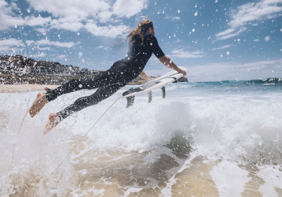 Surfer heading out to catch a wave at Bronte Beach, Sydney