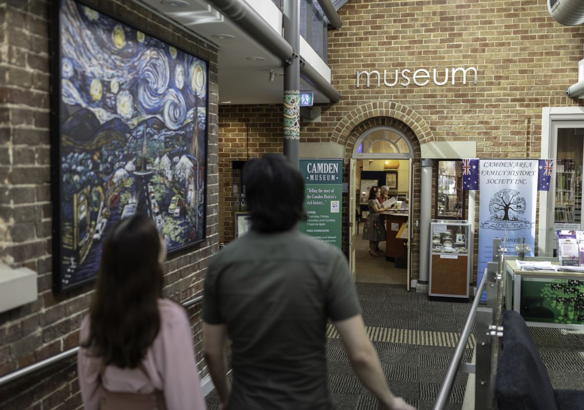 Couple learning about the cultural and heritage background of Camden at the Camden Museum in Sydney's west
