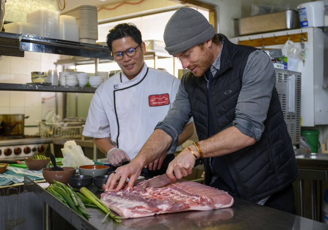 Chef Will Mahusay and owner of Sydney Cebu Lechon, Hayden preparing the pork belly,  Parramatta