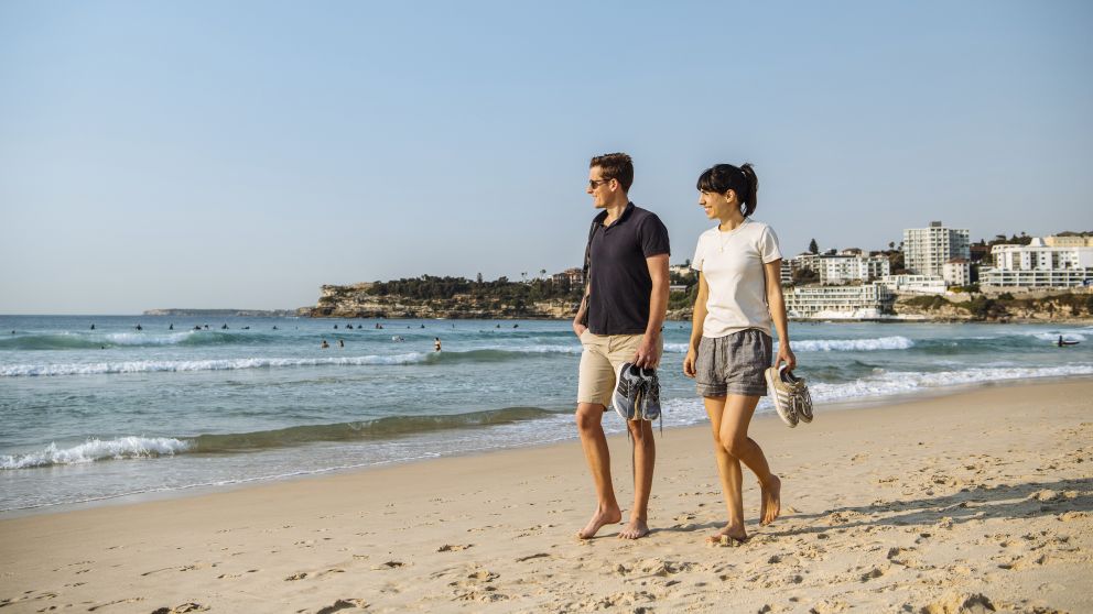 Couple enjoying a walk along Bondi Beach in Bondi, Sydney