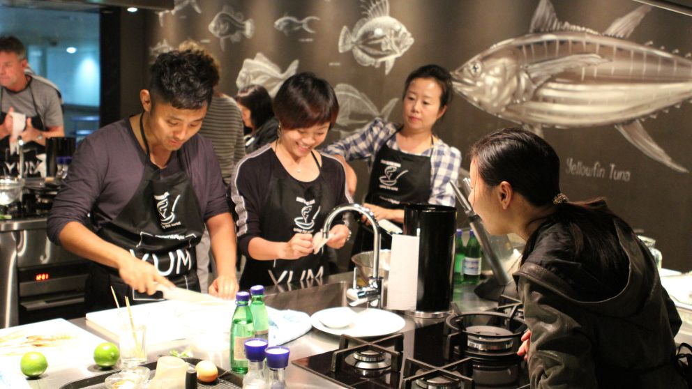 Small group enjoying a cooking class at the Sydney Seafood school, Sydney Fish Market
