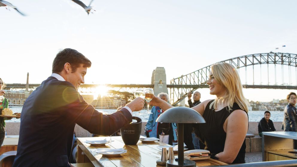 Couple enjoying sunset drinks at the Opera Bar, Sydney Opera House