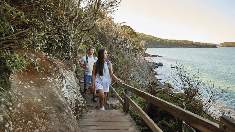 Couple enjoying the walk from Spit Bridge to Manly with scenic views across Sydney Harbour, Sydney
