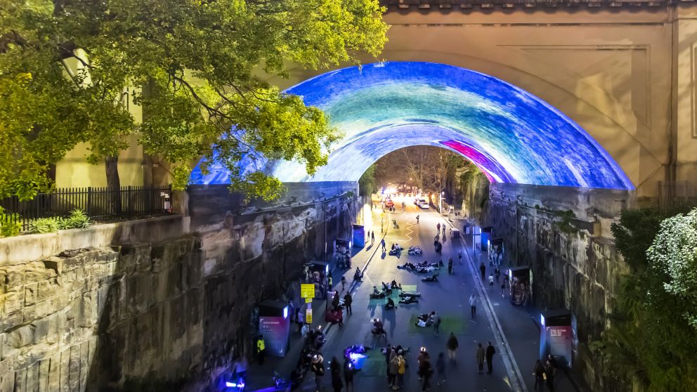 Crowds enjoying the Pixar: 30 Years of Animation light projection on the Argyle Cut, The Rocks during Vivid Sydney