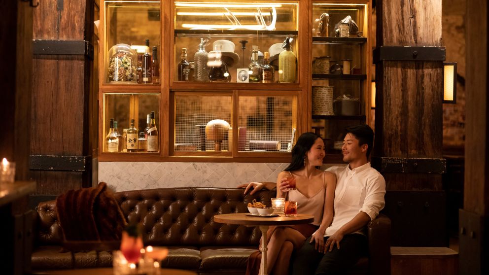 Couple enjoying bar snacks and cocktails at Palmer and Co., Sydney