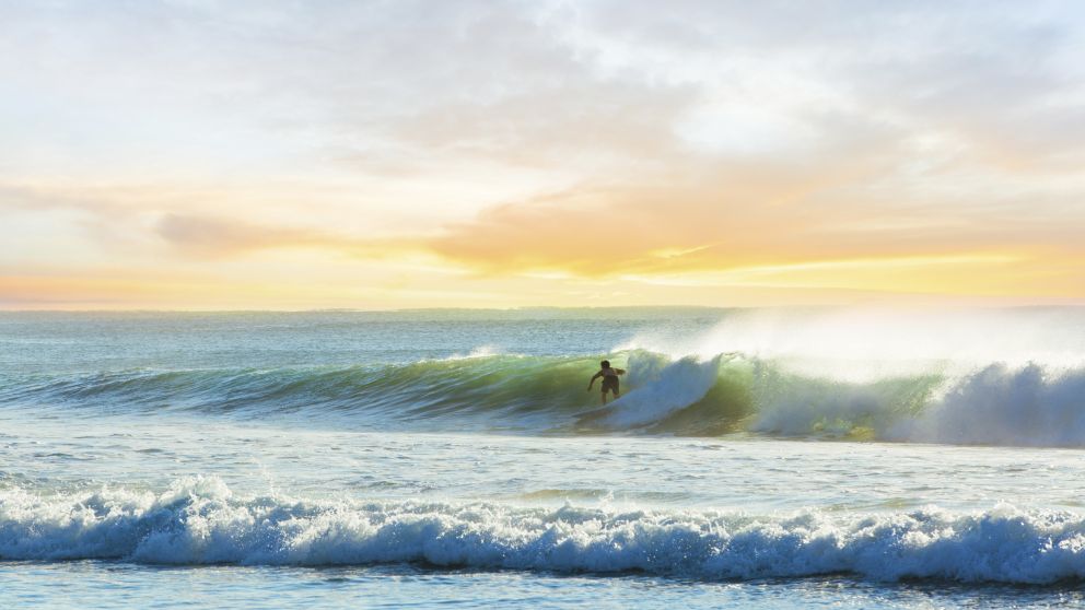 Surfer riding a wave at Manly Beach in Sydney's north