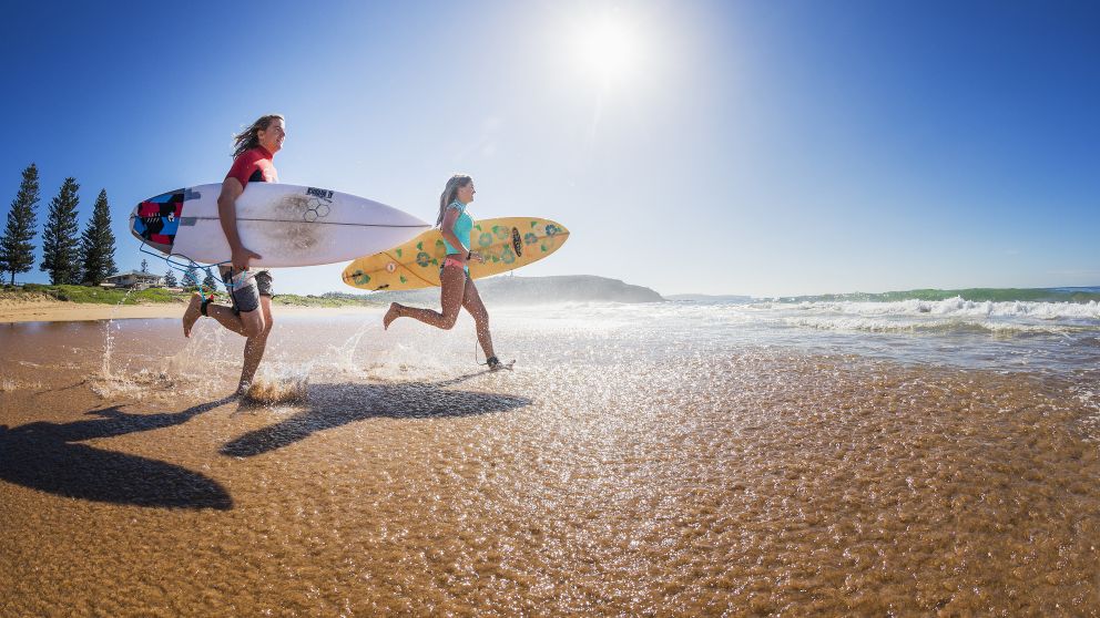Two surfers heading out to enjoy the morning waves at Sydney's Palm Beach