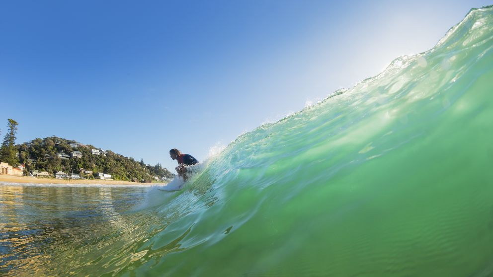 Man enjoying a morning surf at Sydney's Palm Beach