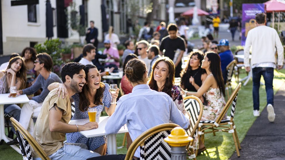 Friends enjoying drinks in the afternoon at the Orient Hotel in The Rocks, Sydney City