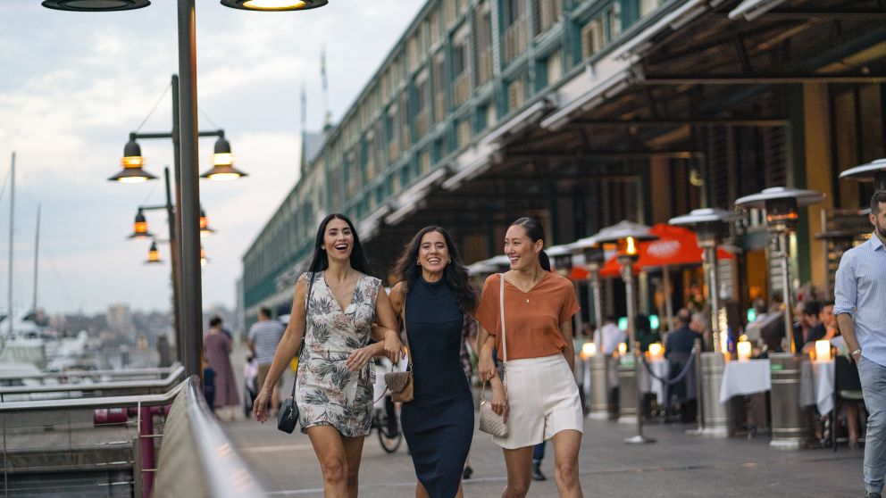 Friends walking along the Finger Wharf at Woolloomooloo, Sydney City