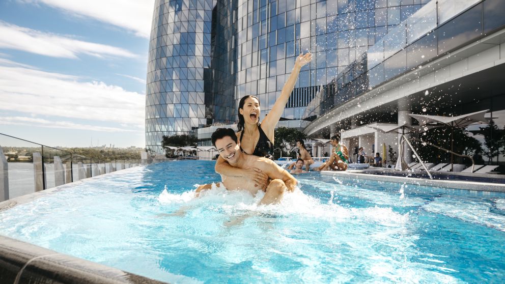 Couple enjoying the luxurious pool at Crown Towers hotel in Crown Sydney, Barangaroo