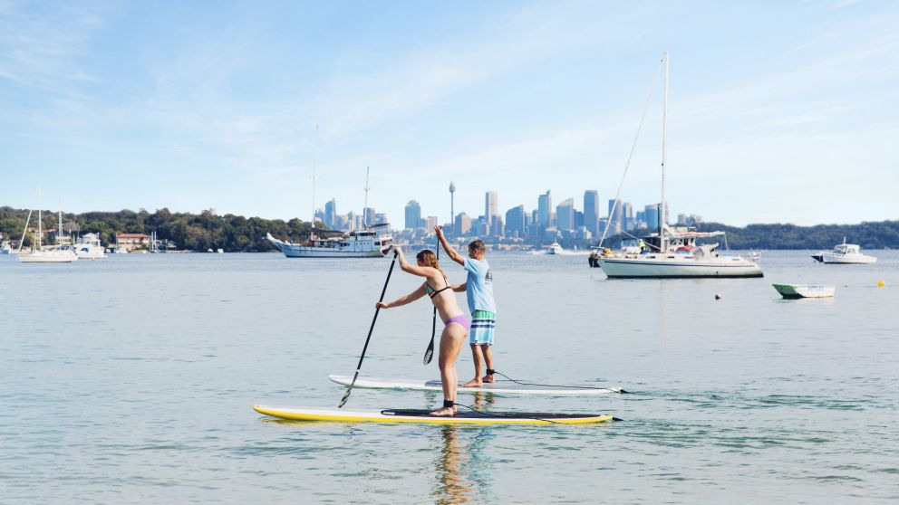 Couple enjoying a morning of stand up paddleboarding at Watsons Bay, Sydney East