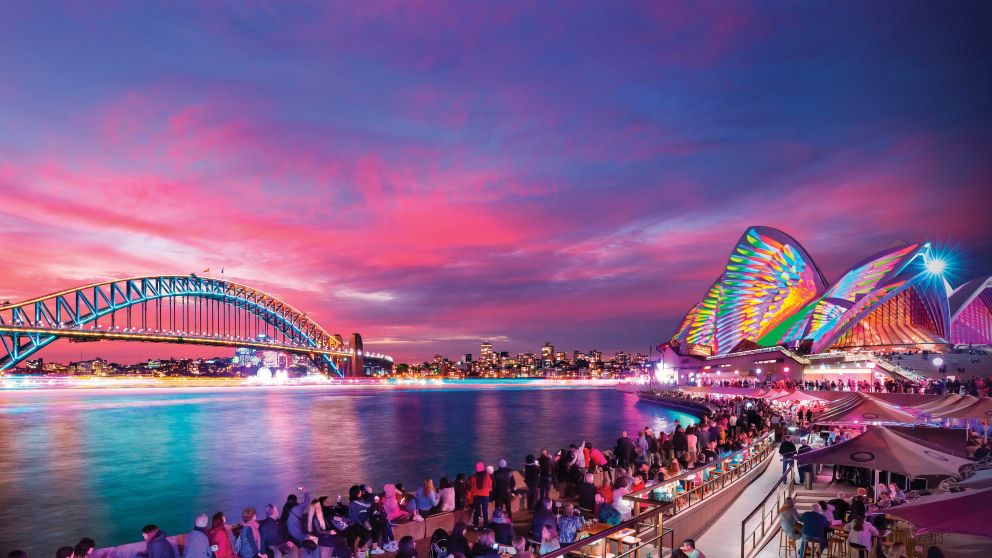 Patrons at Opera Bar enjoying the sunset and light projections during Vivid Sydney 2018